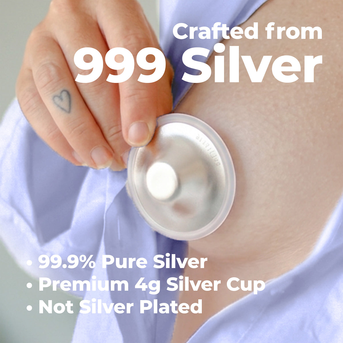 A close-up of a person's hand holding a round silver cup against their upper arm, with large white text reading 'Crafted from 999 Silver' and additional text listing '99.9% Pure Silver', 'Premium 4g Silver Cup', and 'Not Silver Plated'.